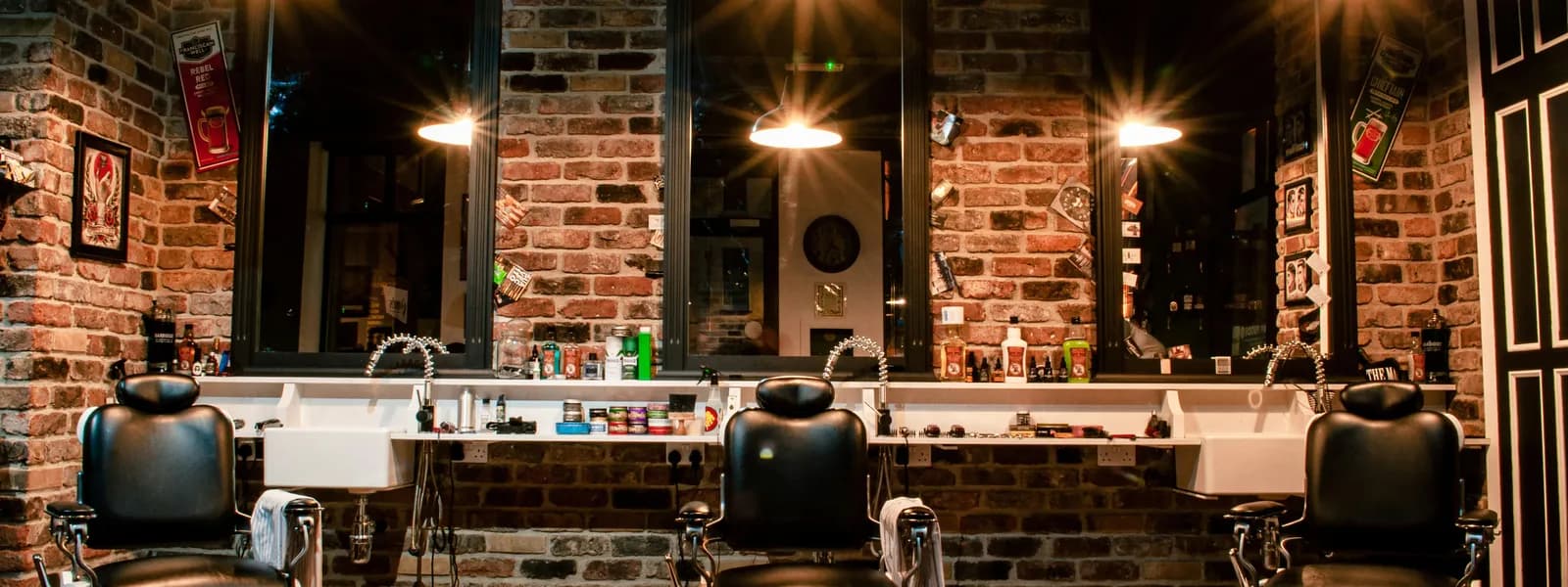 Interior of a professional barber shop with warm lighting and vintage decor