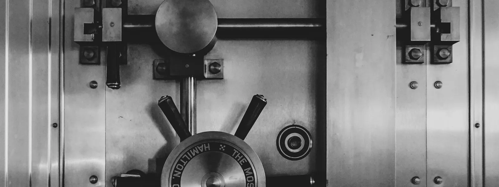 Steel bank vault door with combination lock representing robust security